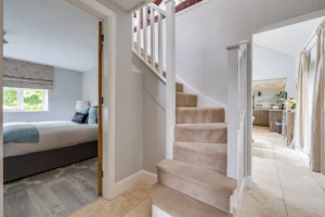 Exposed beam staircase and landing within barn conversion