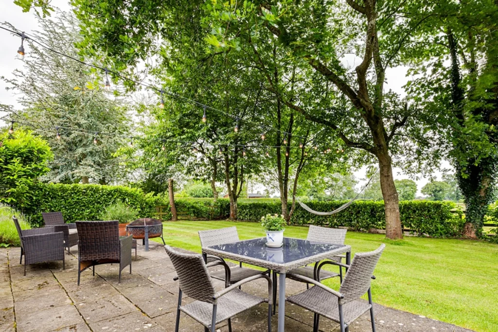 Landscaped patio and garden seating area outside barn conversion