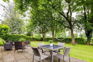 Landscaped patio and garden seating area outside barn conversion
