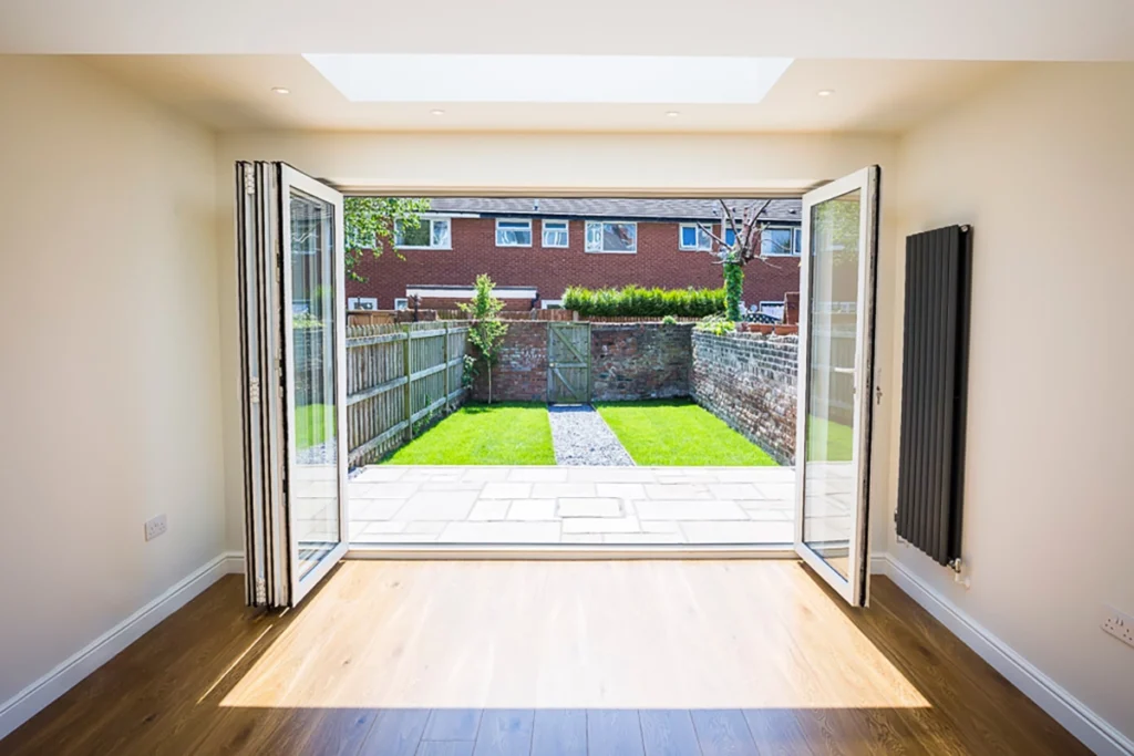 Open plan kitchen extension with bifold doors opening to garden